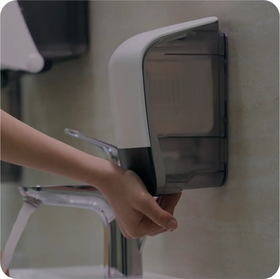 person using soap dispenser